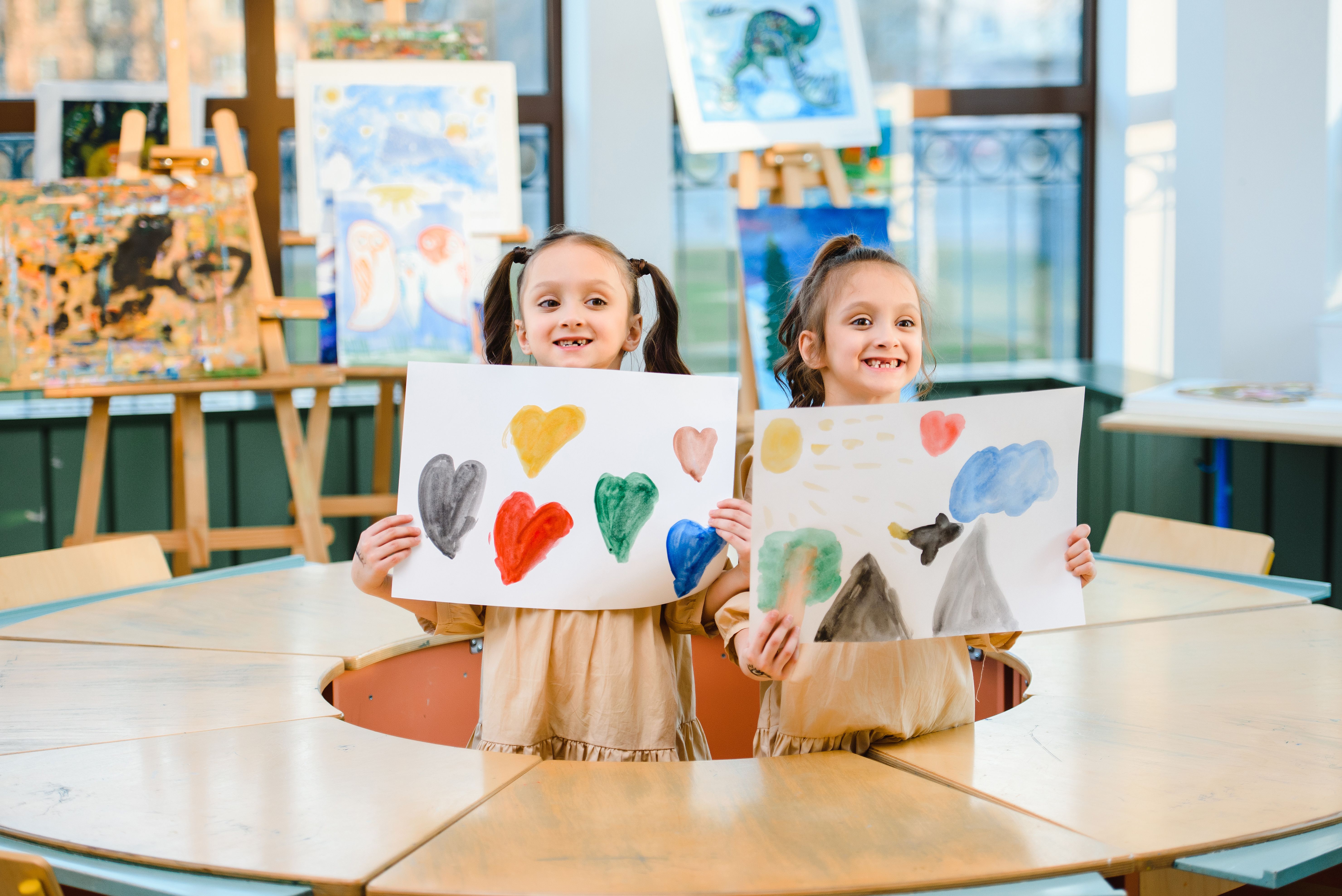 Children at after school club holding artwork, safeguarding after school clubs 2026